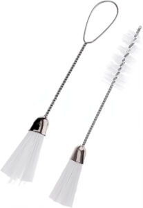 Small angled lint cleaning brush for sewing machine bobbin area and feed dogs maintenance